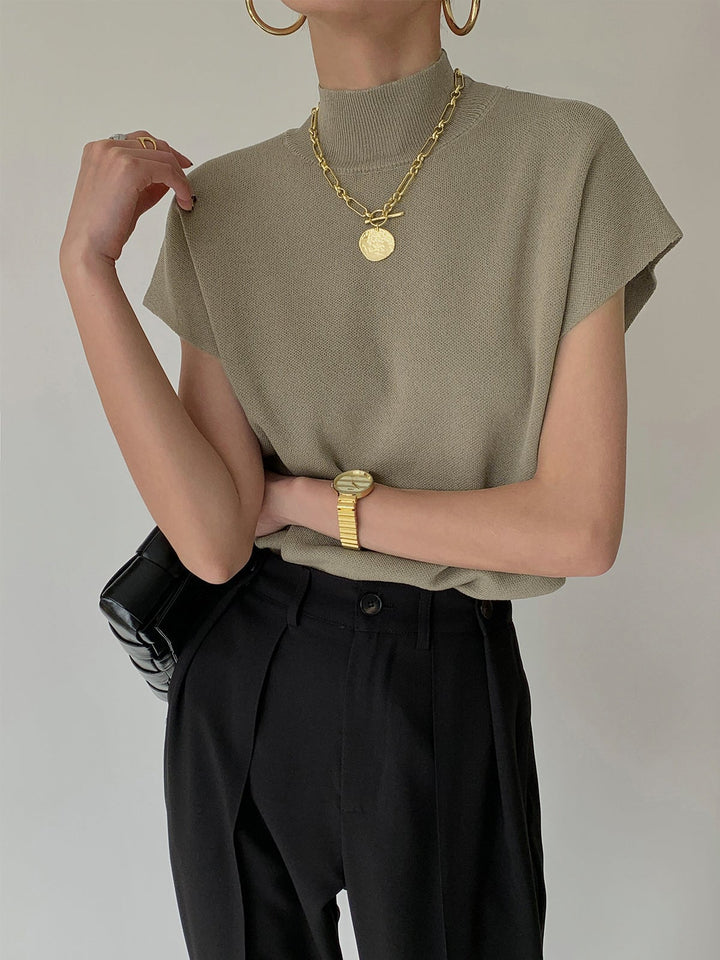 Back view of the Noira mock neck sleeveless knit top in black