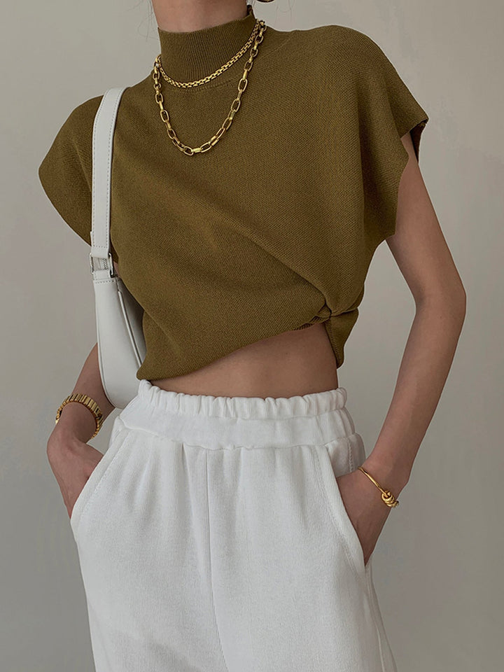 Close-up of the mock turtleneck collar detail on the Noira knit top in black