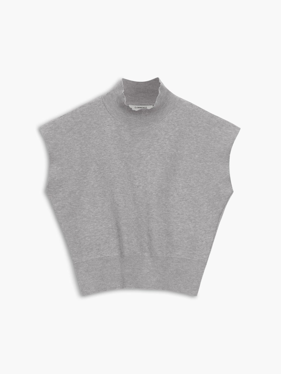 Model wearing the Noira mock neck knit top in black with tailored trousers