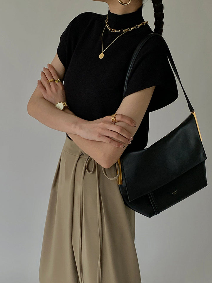 Noira mock neck knit top in khaki on model, front view