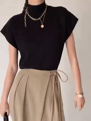 Model wearing the Noira top in khaki styled with neutral trousers