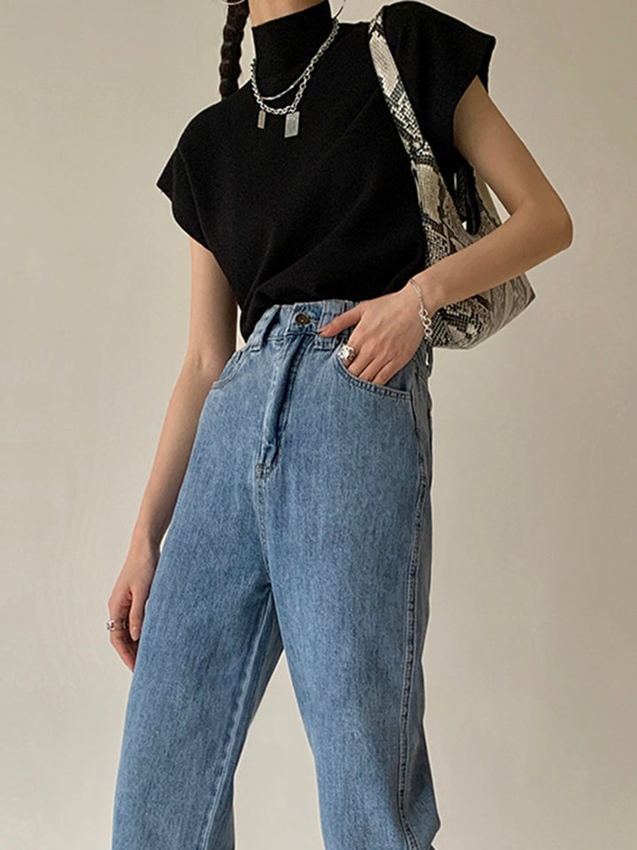 Noira knit top in light brown styled with wide-leg jeans on model