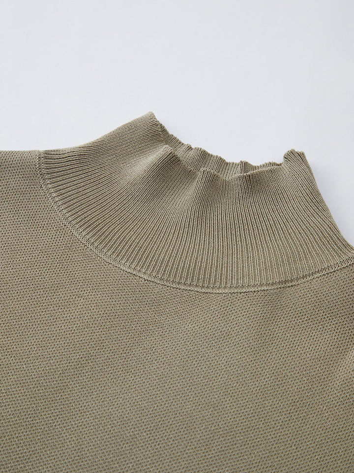 Model wearing the Noira mock neck top in light grey styled casually