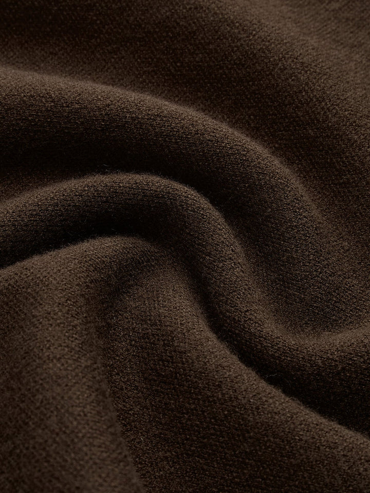 Flat lay of the Noira mock neck sleeveless knit top showing padded shoulder and knit texture detail