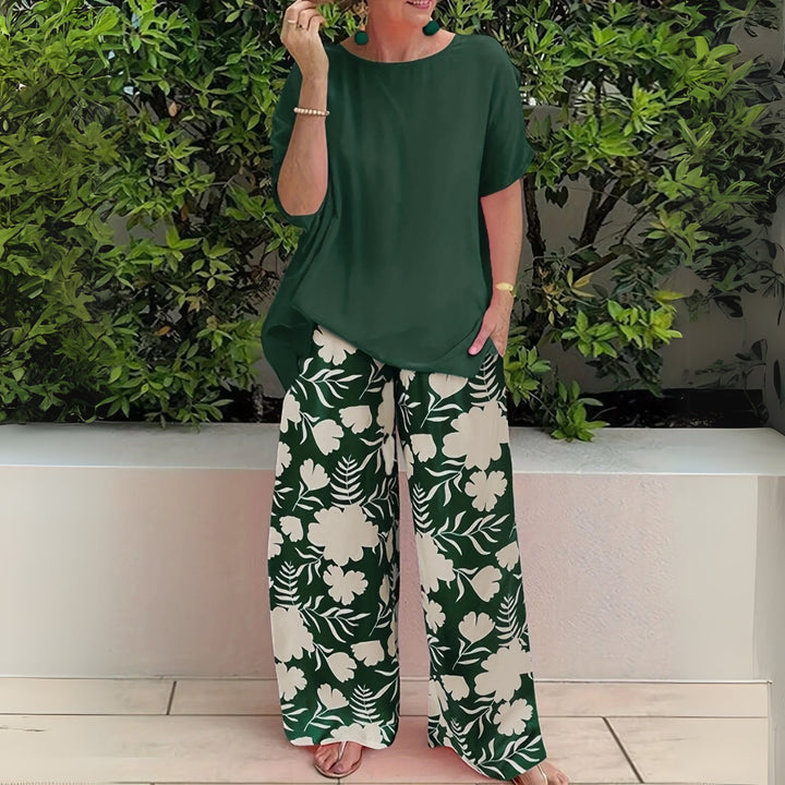 Model wearing the Nora floral two-piece set with wide-leg pants in Forest Green, shown front view