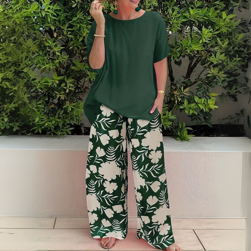 Model wearing the Nora floral two-piece set with wide-leg pants in Forest Green, shown front view