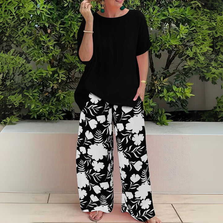 Close-up of the Nora floral wide-leg pants and relaxed top in Mandarin Orange highlighting the fabric and print detail