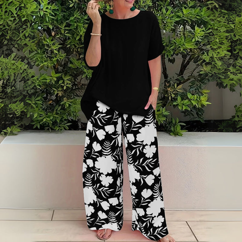 Close-up of the Nora floral wide-leg pants and relaxed top in Mandarin Orange highlighting the fabric and print detail