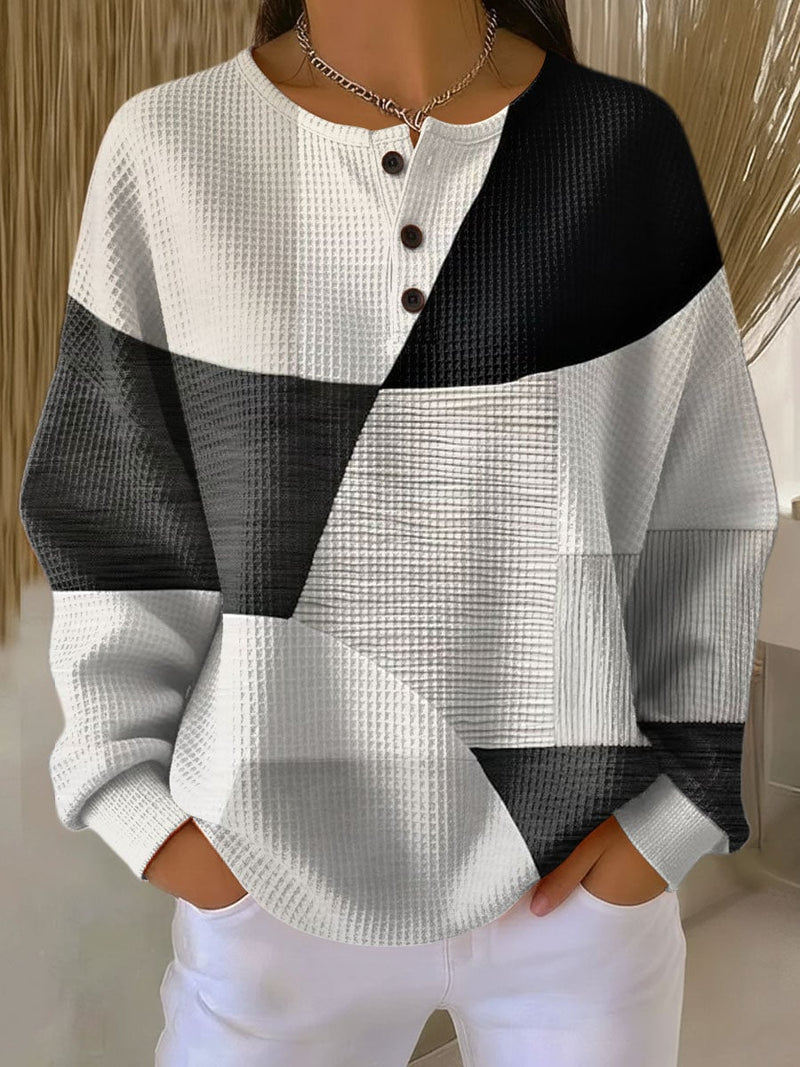 Woman wearing the Nora classic pullover in a multicolor style, featuring a relaxed flattering fit and clean lines