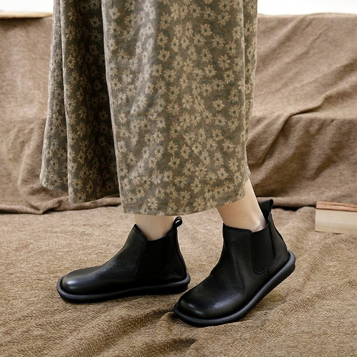 Nora slip-on boots in black with a sleek minimalist silhouette, front view