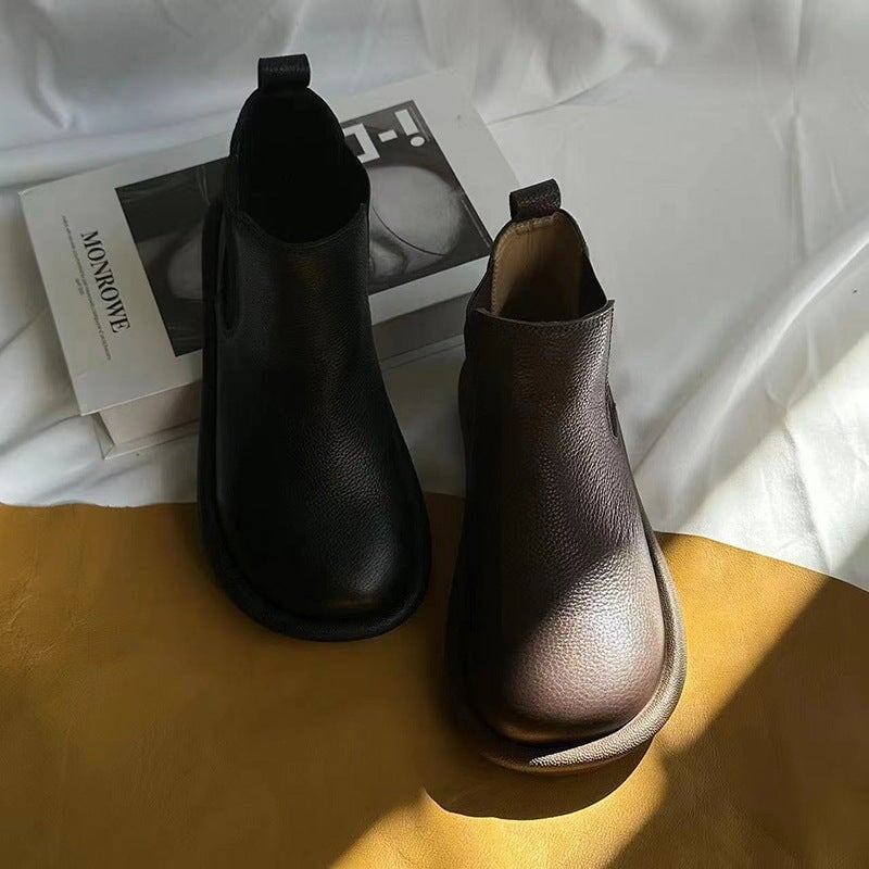 Nora slip-on boots in black and brown displayed side by side for color comparison