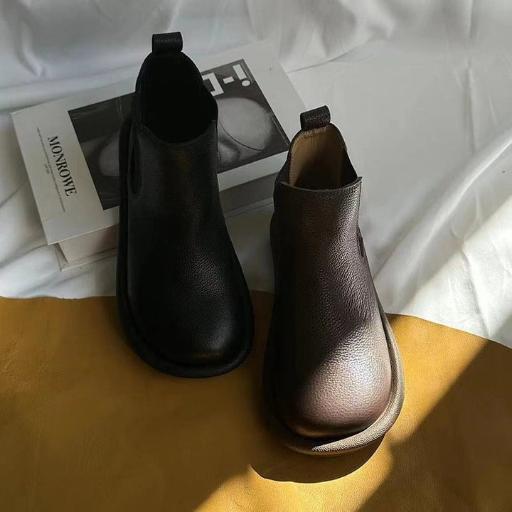 Nora slip-on boots in black and brown displayed side by side for color comparison