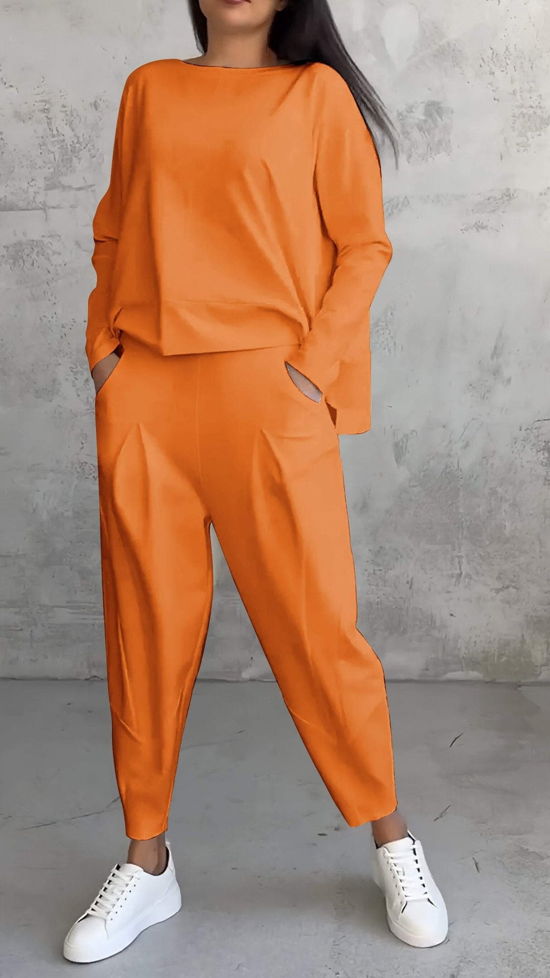 Side view of the Nora black lounge set highlighting the pleated tapered pants and oversized top fit