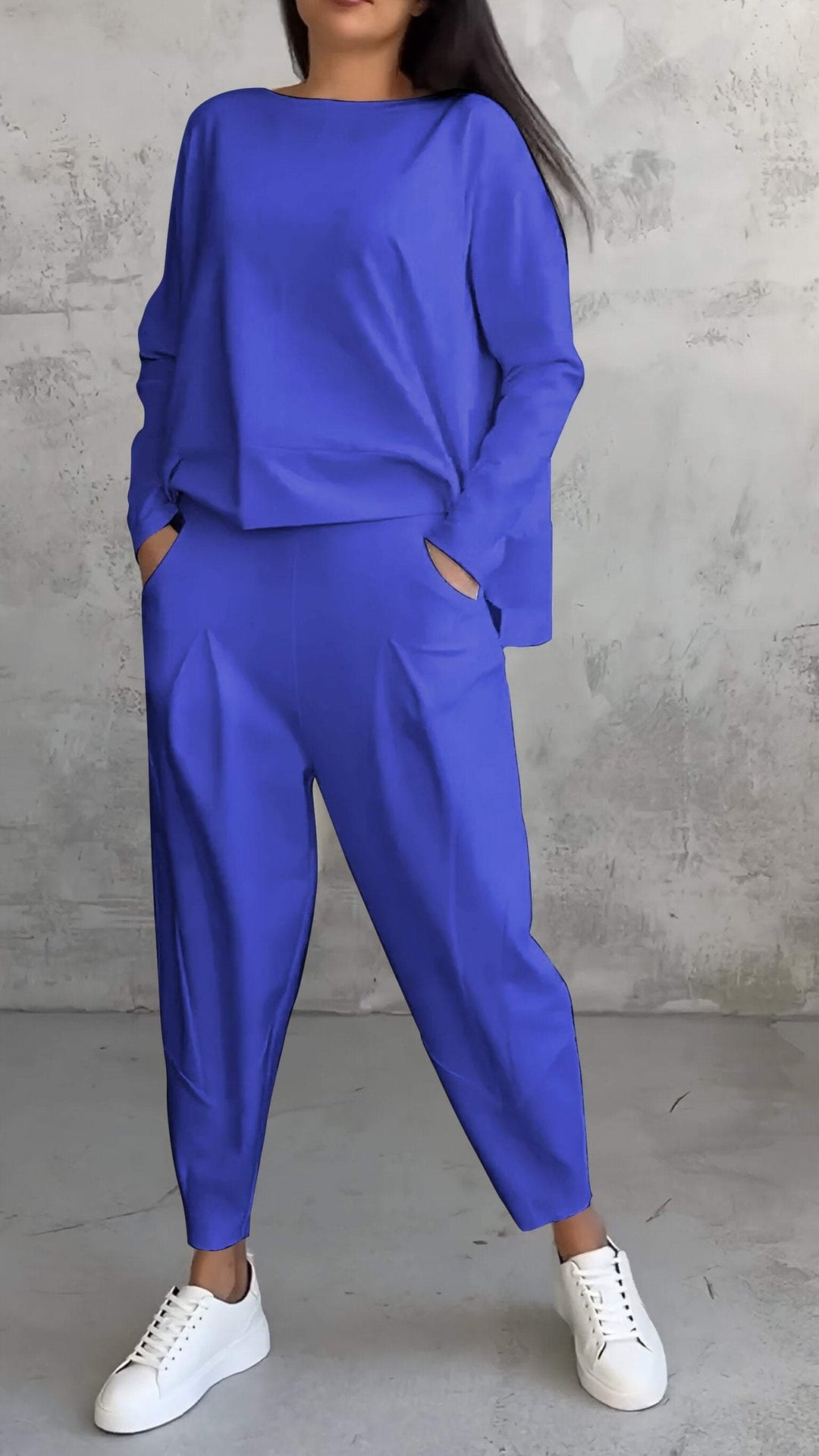 Woman wearing the Nora red long-sleeve lounge set, styled with casual slides, full-length view