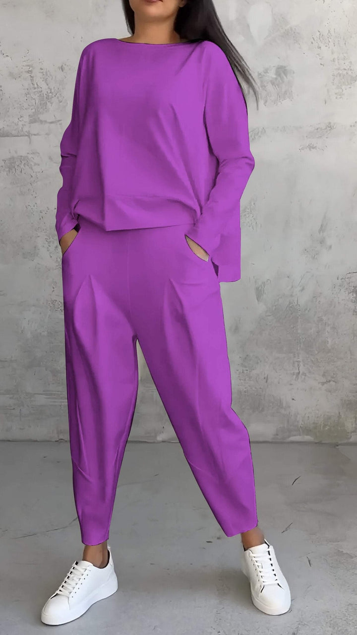 Woman in the Nora dark blue lounge set with pleated pants and relaxed boat-neck top, full-length shot