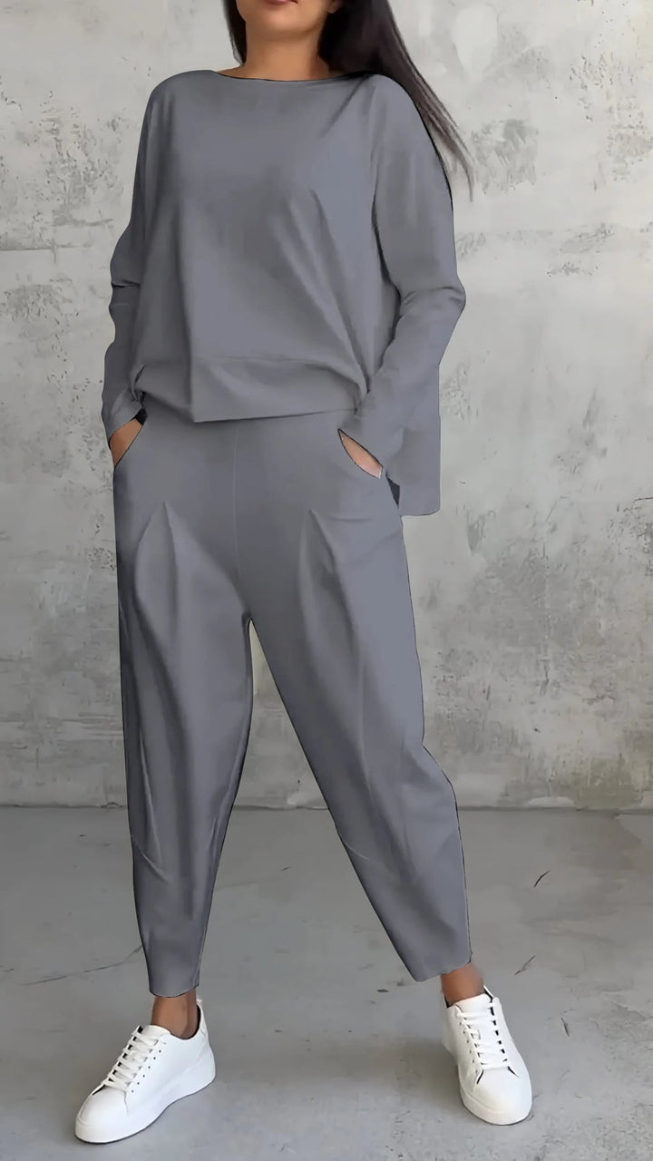 Close-up of the Nora green lounge set pleated pant front detail and tapered ankle-length leg
