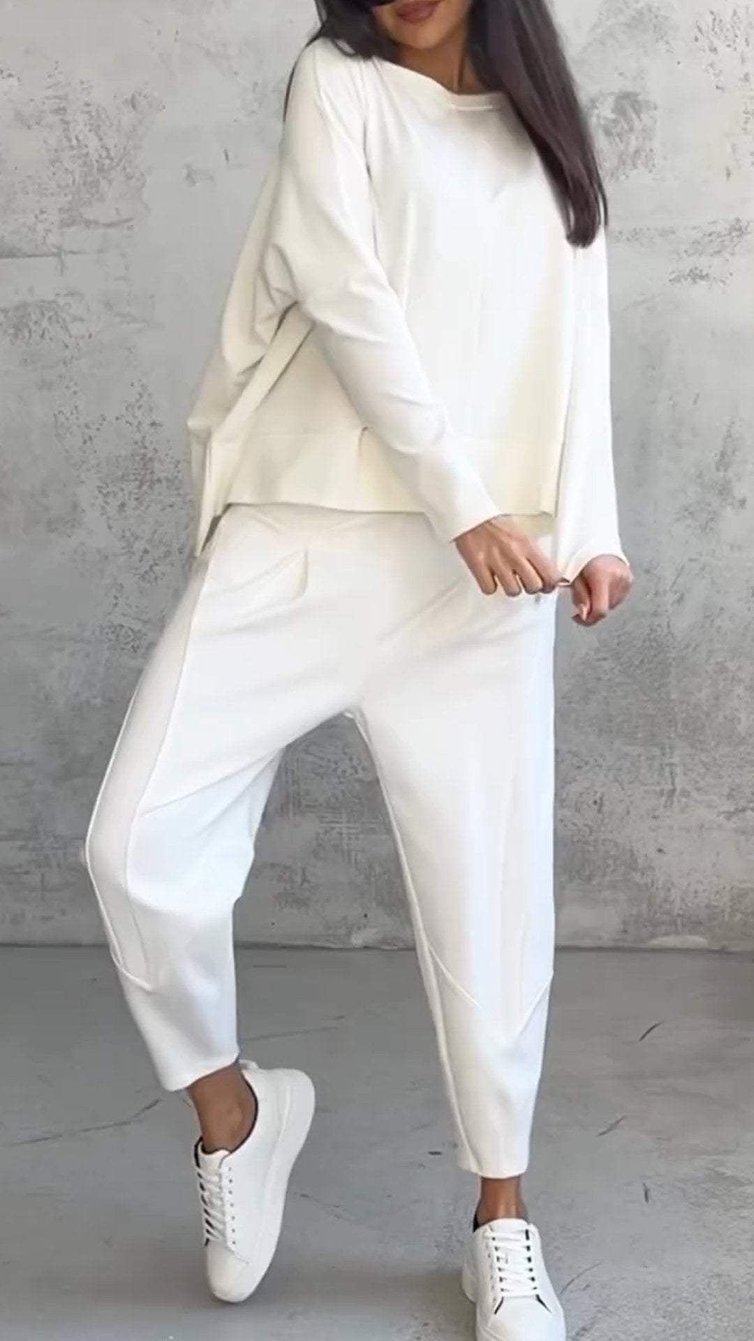 Woman wearing the Nora purple 2-piece lounge set, side pose showing relaxed oversized top silhouette
