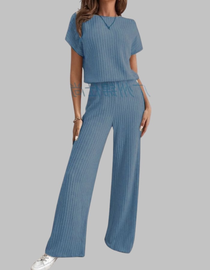 Side view of the Nora ribbed two-piece set showing the long wide-leg silhouette in apricot