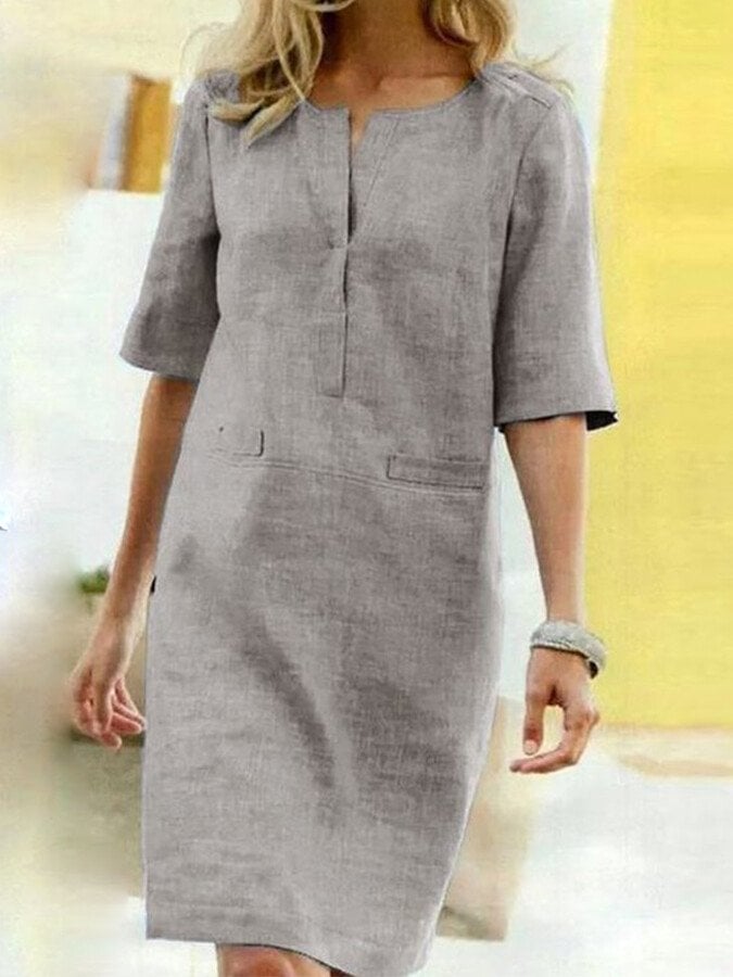 Side view of the Nora shift dress in Light Gray highlighting the half sleeve length and clean knee-length cut