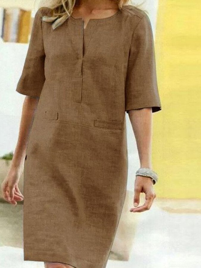 Close-up detail of the notched V-neckline on the Nora linen-look shift dress in Brown