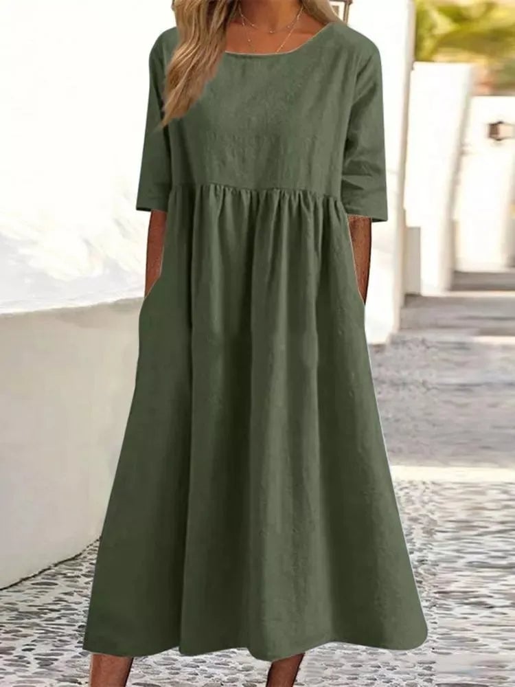 Front view of the Norah spring dress in navy blue, modeled with minimal accessories