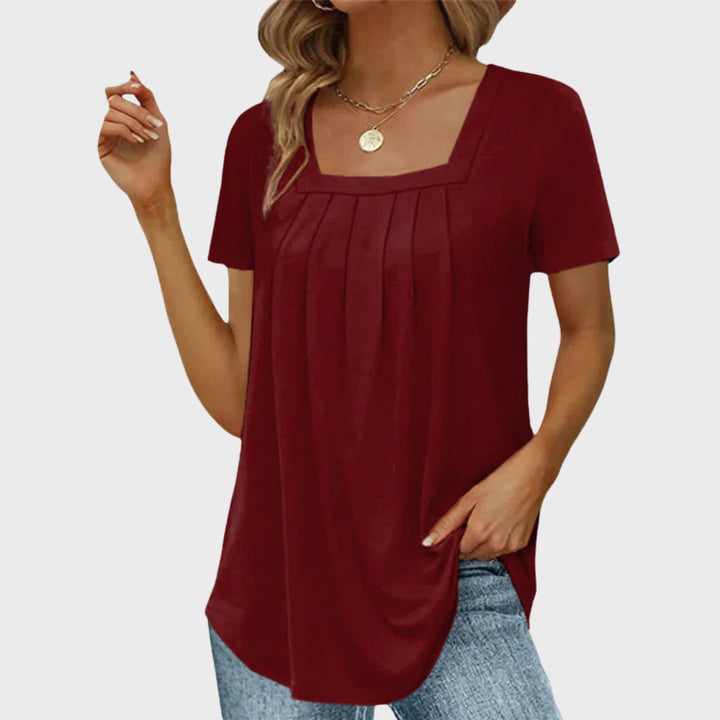 Side view of a breathable short-sleeve blouse showing relaxed drape and structured silhouette