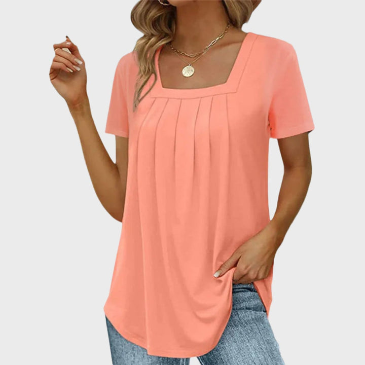 Detail shot of the short sleeve and neckline finish on a breathable summer blouse in mint green