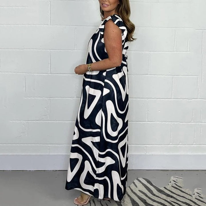 Back view of the Nova abstract print V-neck ruffle sleeve jumpsuit in Carbon Black