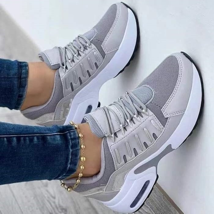 Nova chunky platform sneakers in white with gold accent midsole, front three-quarter view