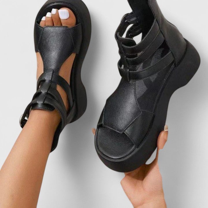 Nova women's black chunky platform sandals with crossed multi-strap upper and ankle buckle closure, front view