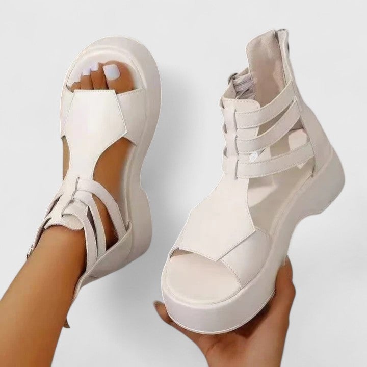 Nova white platform sandals showing chunky sole height and layered strap detail, angled view
