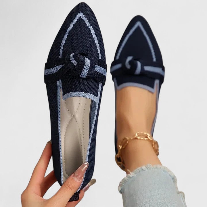Nova slip-on flat loafers in black with knot detail, angled top view
