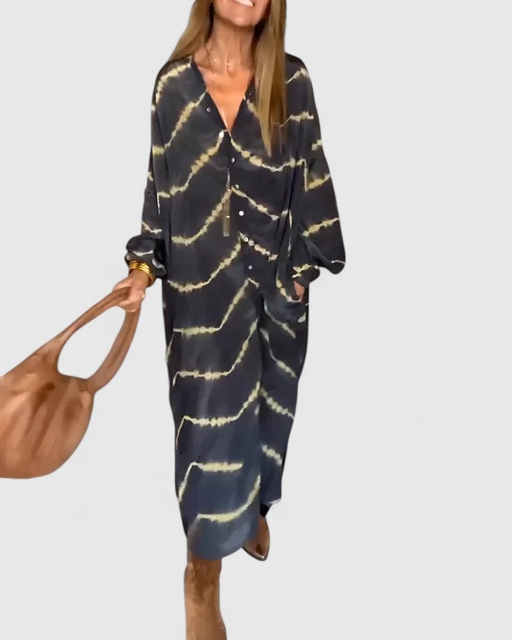 Front close-up of the Nova tie-dye shirt dress showing V-neckline, button placket, and abstract charcoal and gold print detail
