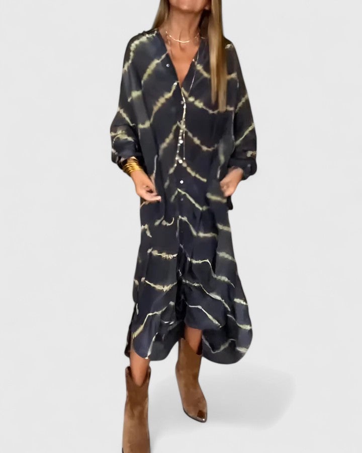 Side view of the Nova midi shirt dress highlighting the oversized dropped-shoulder silhouette and hi-low curved hem