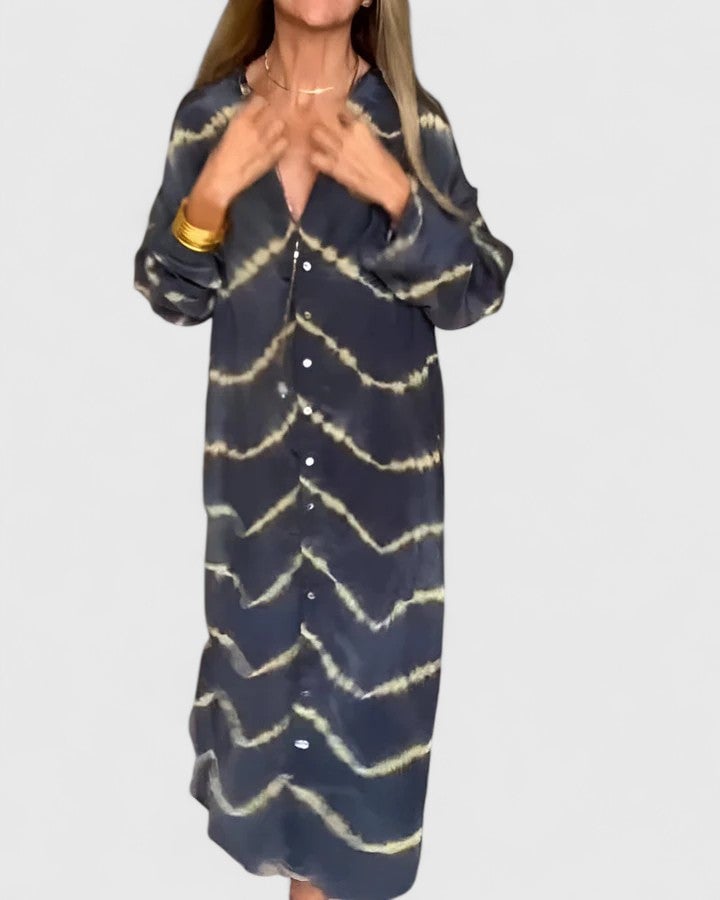 Back view of the Nova tie-dye midi shirt dress showing the longer curved hem and full-length sleeves in black tie-dye print