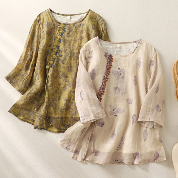 Front view of a cream floral embroidered relaxed blouse showing button front and collar detail