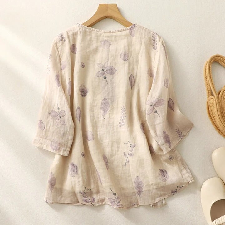 Close-up of intricate floral embroidery stitching along the bodice and sleeves of a relaxed blouse