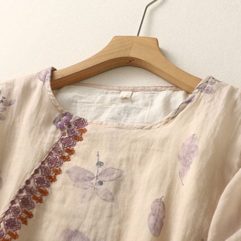 Side view of a flowing green floral blouse showing relaxed hip drape and sheer panel contrast