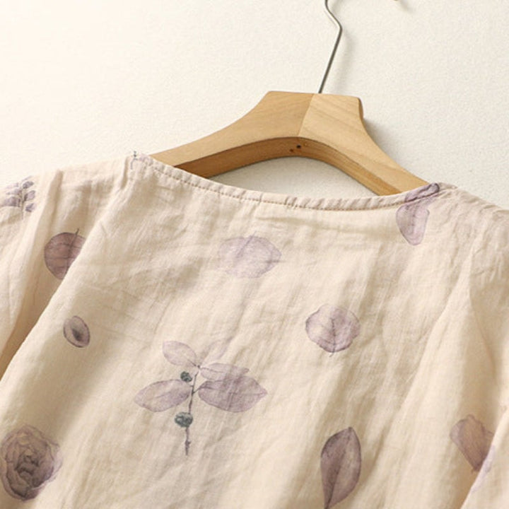 Detail shot of the timeless collar and button front on a floral relaxed blouse in green