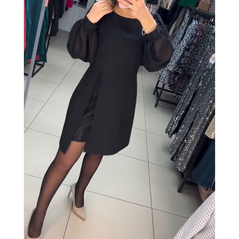 Model wearing the Nyla elegant timeless dress in black, showcasing its flattering tailored silhouette