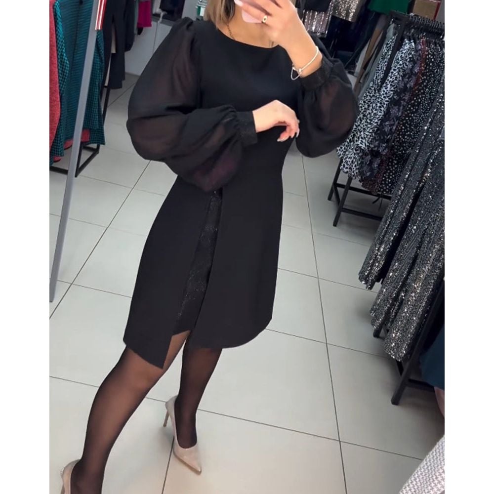 Model posing in the Nyla elegant timeless dress styled for a special occasion