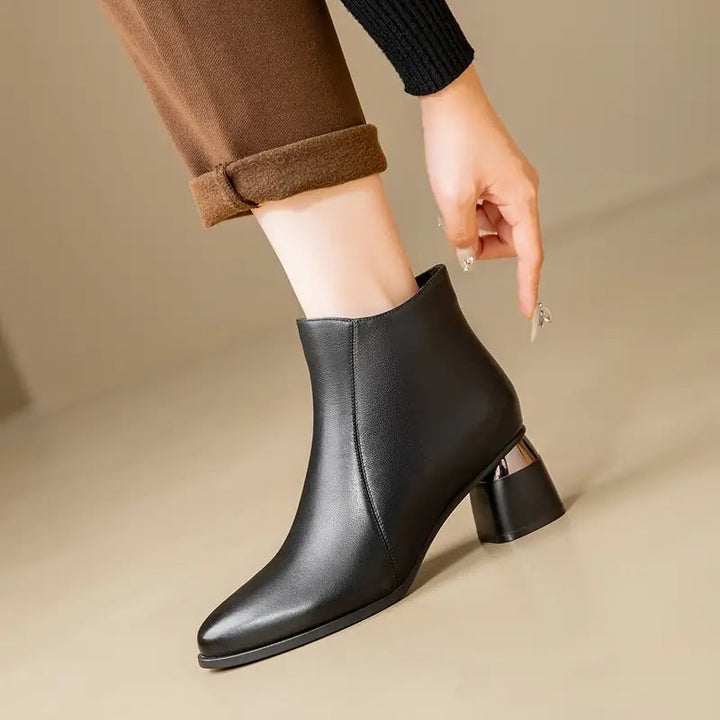 Nyla sleek women's boots in black with a smooth contoured silhouette, front view