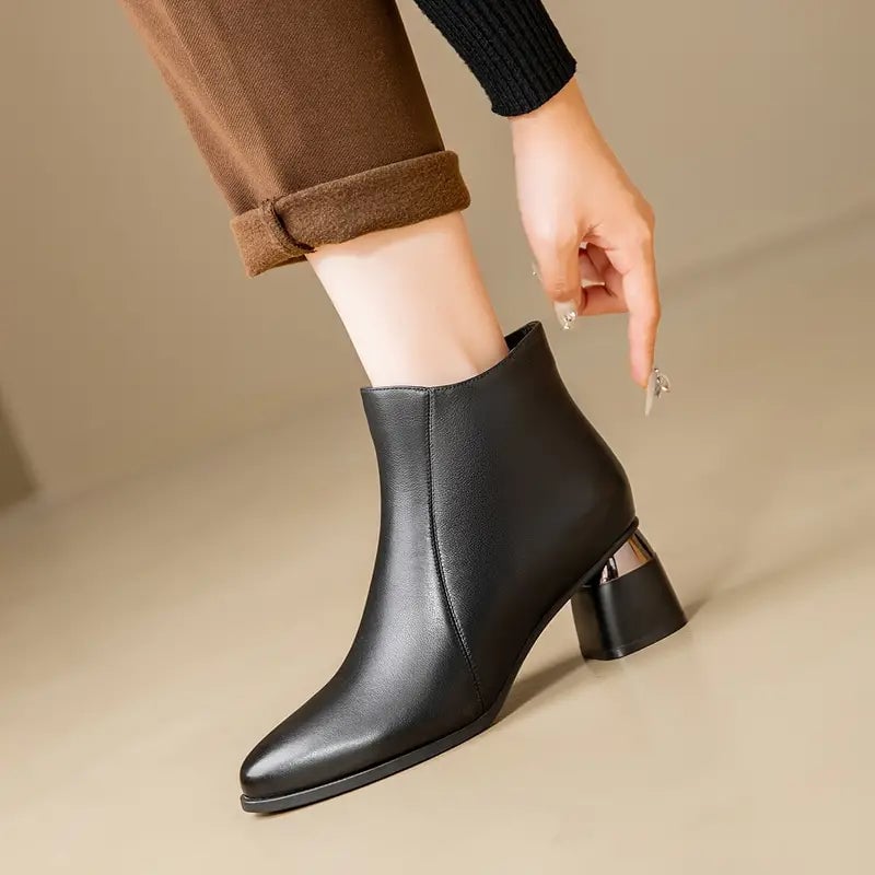 Nyla sleek women's boots in black with a smooth contoured silhouette, front view