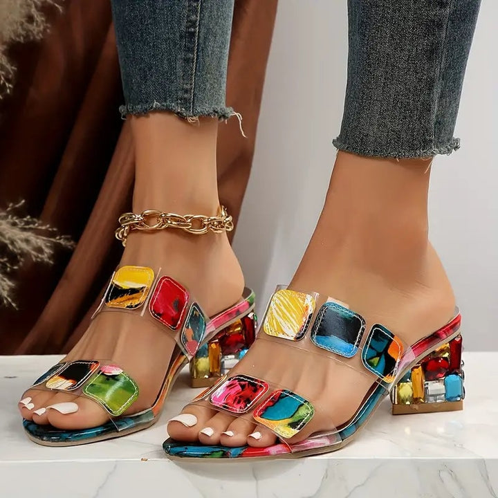 Pair of Nyla vibrant double-strap flat sandals displayed on a neutral background, rear three-quarter view