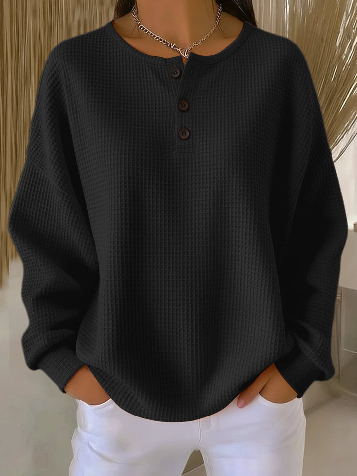 Side profile of model wearing the Florimay casual sweatshirt in black, highlighting the relaxed fit and sleeve length