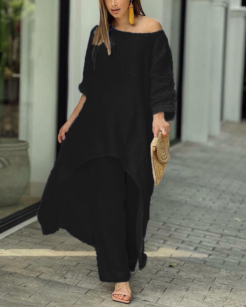 Woman wearing the Oasis linen two-piece set with longline tunic and wide-leg pants in natural beige