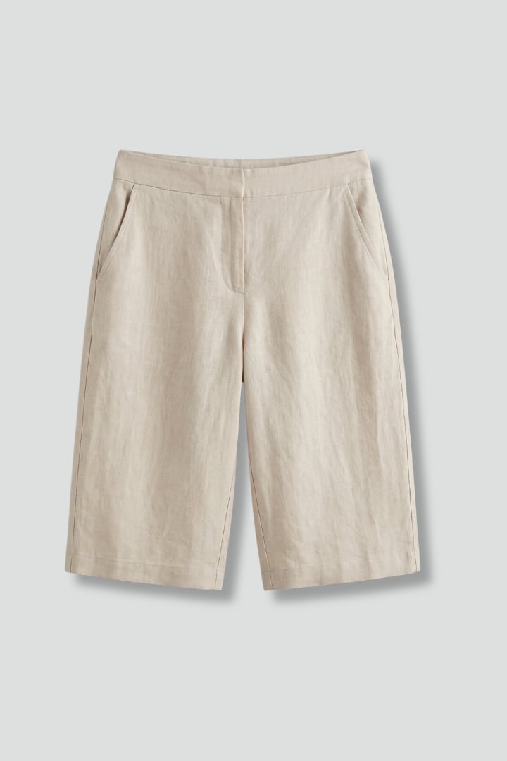 Octavia high waisted knee length shorts in beige with elastic drawstring waistband, front view