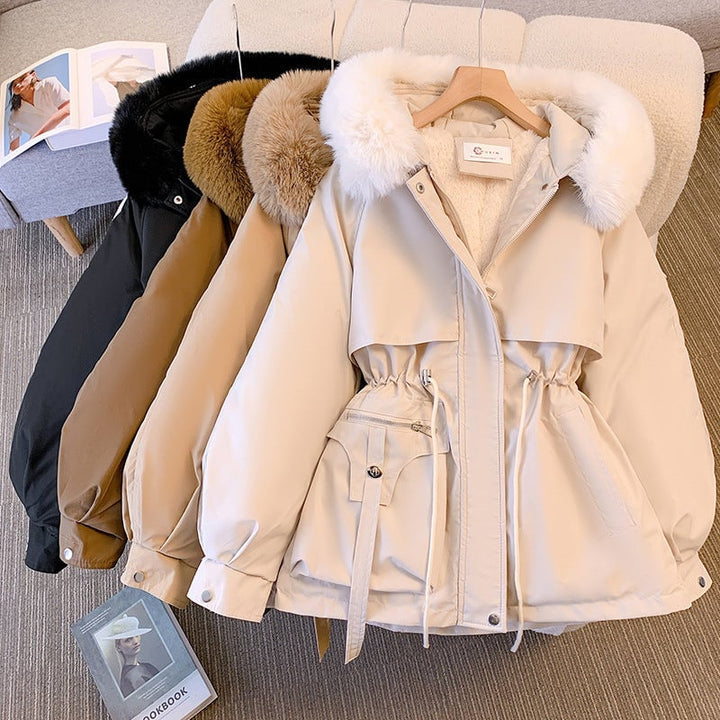 Woman wearing the Odette white fur-trimmed winter coat with plush faux fur hood, front view