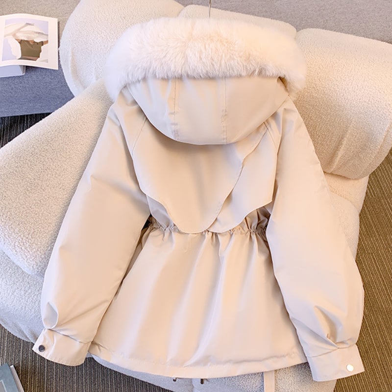Detail shot of the Odette winter coat fabric texture and adjustable waist tie