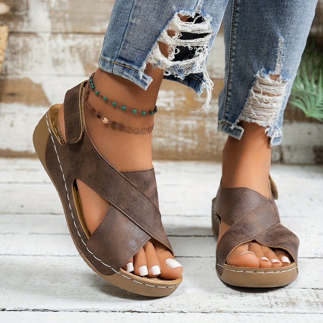 Close-up of cushioned insole and platform sole on Olive wedge sandals in black
